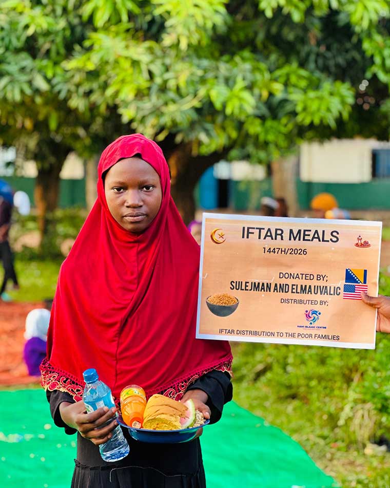 Ugandan-Muslim-school-girl-holding-a-palte-of-rice-during-our-feeding-programme